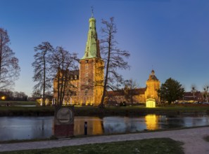 View in winter over partially frozen moat at castle converted into a Renaissance castle today