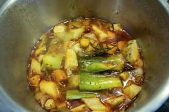 A vegetable stock is cooked, various vegetables are boiled with spices and herbs in water for a