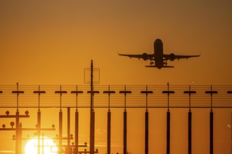 Runway lighting, approach aids, at Düsseldorf International airport, sunset, aviator taking off, in