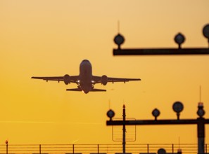 Runway lighting, approach aids, at Düsseldorf International Airport, sunset, aircraft taking off,