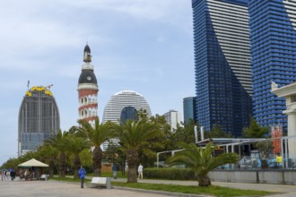 A mix of modern skyscrapers and a round tower offers a contrasting city view under cloudy sky,