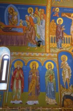 Detailed Orthodox frescoes depicting saints and religious scenes in vivid colors, St. Barbara