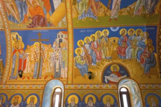 Frescoes in an Orthodox church depict saints and religious scenes in bright colors, St. Barbara