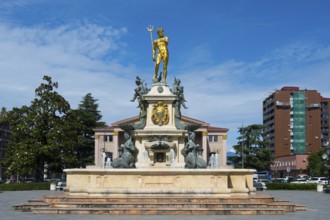 A fountain with a golden Neptune statue surrounded by water figures in front of a building, Neptune