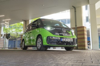 VW vehicle under a covered area in urban architecture, Deer E-Mobility Shuttle Service, Calw,