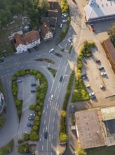 Drone view of a busy road junction with adjacent buildings and vegetation, Deer E-Mobility Shuttle