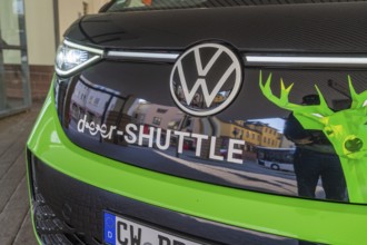 Close-up of the front part of a VW with green-black colors, Deer E-Mobility Shuttle Service, Calw,