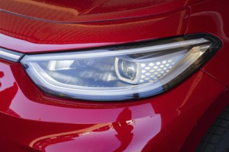 Red car light with modern headlight design in close-up, Deer E-Mobility Shuttle Service, Calw,