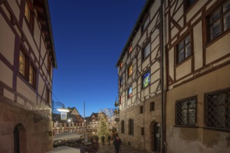 Historic half-timbered houses with a view of the Christmassy decorated Tiergärtnertorplatz in the