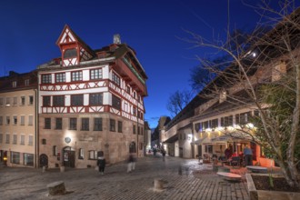 The historic Dürerhaus, on the right the old city wall with a rampart, in evening lighting, Beim