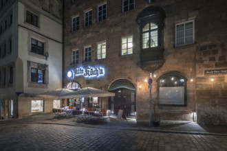Historic restaurant, Alte Küch'n, with choirs in the evening lighting in the old town,