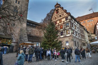 Decorated Christmas tree in front of the historic Pilate House with advent calendar in the evening
