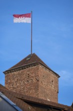 Waving Frankish flag on the Kaiserburg tower, Nuremberg, Middle Franconia, Bavaria, Germany