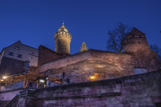 Illuminated Sinwell Tower, built in the 13th century, in the evening sky, Kaiserburg, Nuremberg,