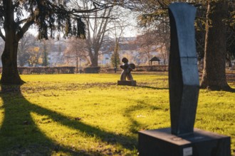 Sculptures on a sunny green area in the park in autumn, Stadtgarten Pforzheim, Germany