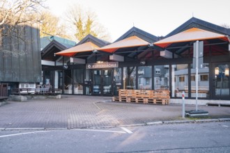 Empty urban building complex surrounded by autumn trees, Stadtgarten Pforzheim, Germany