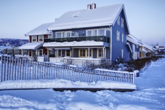Snowy blue house in winter, Mo i Rana, Norway