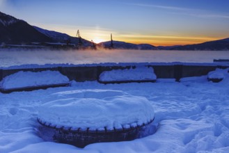 Snowy harbor at sunset, overlooking the water, Mo i Rana, Norway