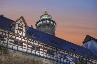 Sinwell Tower built in the 13th century, on the Nuremberg Kaiserburg in the evening lighting, red