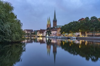 Old town with St. Mary's Church and St. Peter's Church and the Trave at dusk, Lübeck,