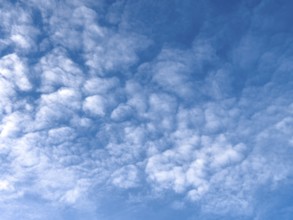 Medium-height white clouds of Altocumulus in blue sky, international