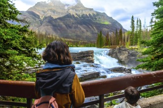 Tourists are enjoying the breathtaking view of athabasca falls, a powerful waterfall located in