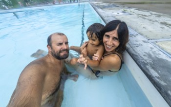 Happy family taking a selfie while enjoying a relaxing bath in the miette hot springs, located in