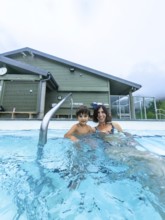 Mother and son are relaxing in a hot spring at miette hot springs in jasper national park, alberta,