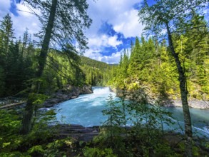 Majestic overlander falls cascading into the vibrant turquoise waters of the fraser river,