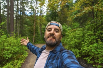 Happy hiker taking a selfie with open arms while walking the overlander falls trail in mount robson
