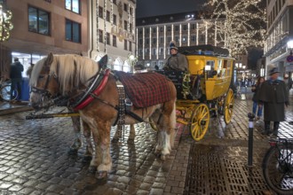 Horse-drawn carriage ride in a historic stagecoach at Chriskindlesmarkt, Hauptmarkt, Nuremberg,