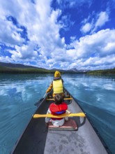 Tourists paddling a canoe on beautiful maligne lake in jasper national park, alberta, canada,