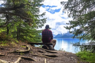 Tourist is enjoying the breathtaking view of turquoise maligne lake and its surrounding mountains