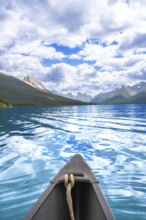 Canoe sailing on the turquoise waters of maligne lake with a stunning view of the canadian rockies
