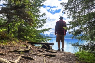 Tourist is enjoying the stunning scenery of turquoise maligne lake and surrounding mountains in