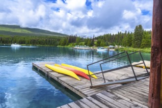 Colorful kayaks lined up on a wooden dock at maligne lake in jasper national park, alberta, while