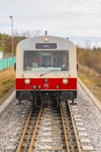 Close-up of a train on the tracks with gray and red front, historic event, first test run with a