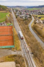 Overview of train travel along tennis courts on the outskirts of the city, historical event, first