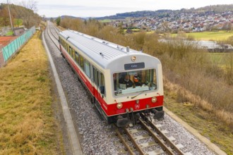 Train on the rails with a view of the city and countryside in the background, inscription 'Calw',