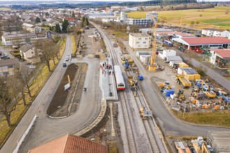 An overview of an urban construction site at a railway station with construction works, vehicles