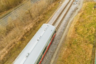 Top view of the top of a train on the rails, surrounded by nature, historic event, first test run
