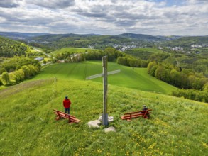 Two hikers under the Silberberg Pilgrim Cross with views over green landscapes, Bad Schlema, Ore