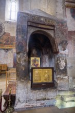 A decorated stone frame with icons in a traditional church interior, Svetitskhoveli Cathedral,