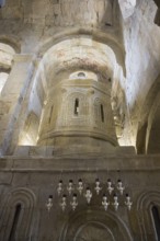 Romanesque church with stone structures and detailed relief decorations in softly lit atmosphere,