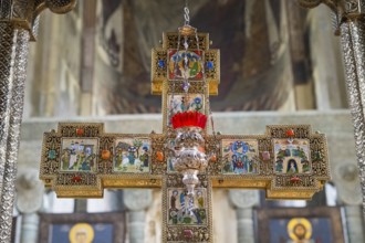 A richly decorated cross with icons and red accents in a church, Svetitskhoveli Cathedral,