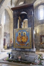 A decorative altar with large colorful icons and sacred art in a church, Svetitskhoveli Cathedral,