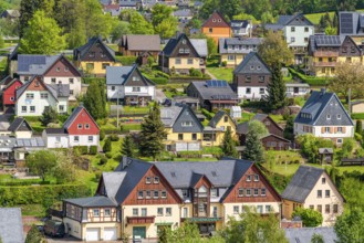 Residential buildings with black roofs and wooden and slate facades, Seiffen health resort and toy