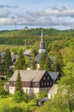 Residential buildings and landmarks of the historic mountain church, in the back forest on