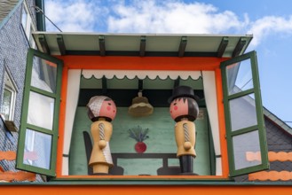 Two large wooden figures of man and woman in a small house, health resort and toy village Seiffen,