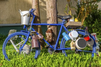 Blue painted bicycle with old pots and jugs, health resort and toy village Seiffen, Ore Mountains,